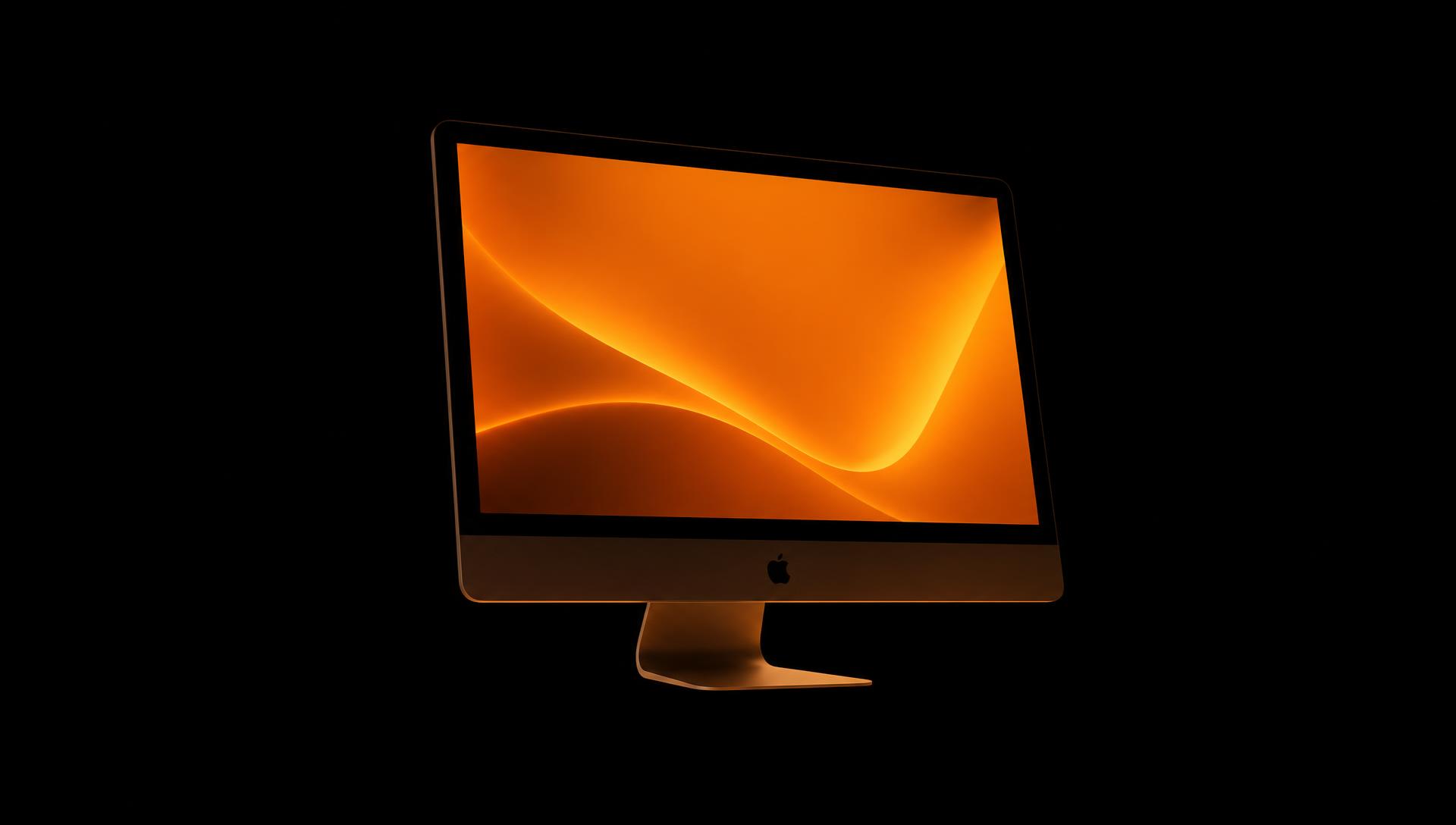 Apple desktop monitor floating in darkness with only the screen glow illuminating the scene